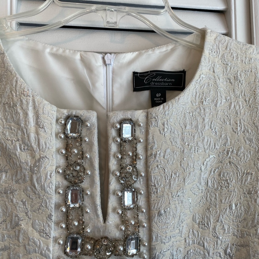 Ivory shift dress with beaded details.